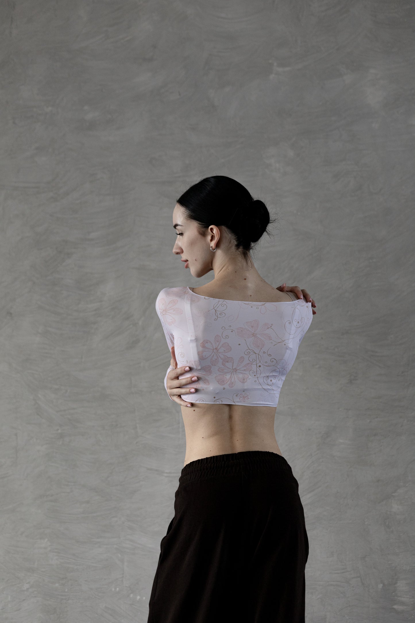 Dancer wearing a powder flower crop top