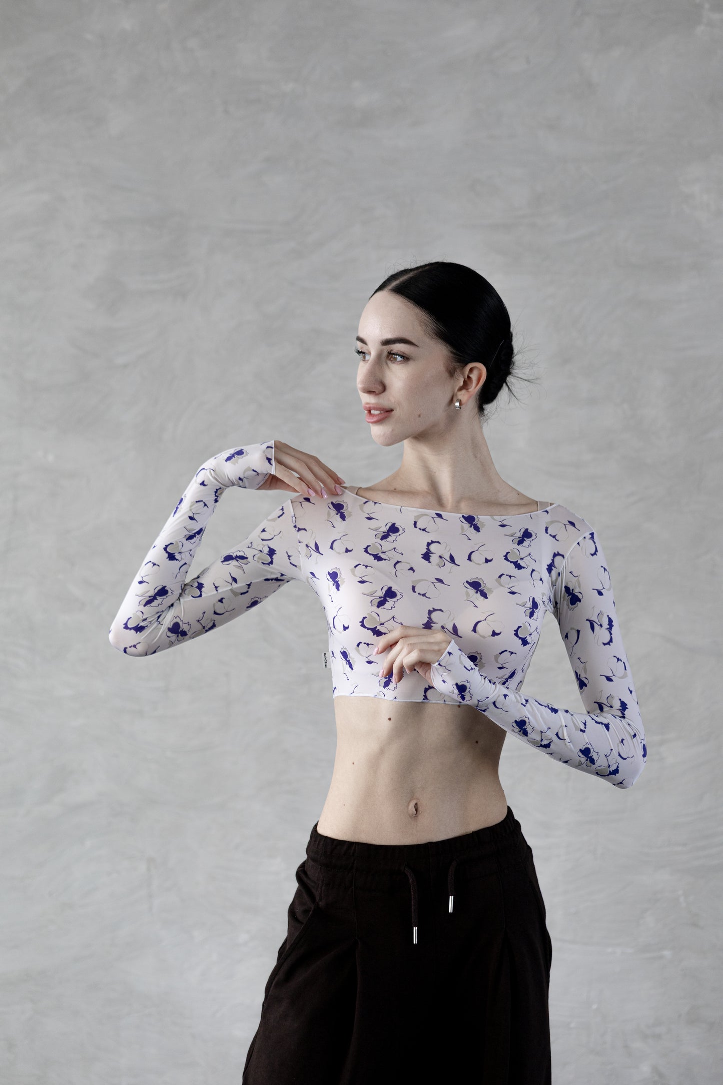 Dancer wearing a white Dancelab top with blue flower