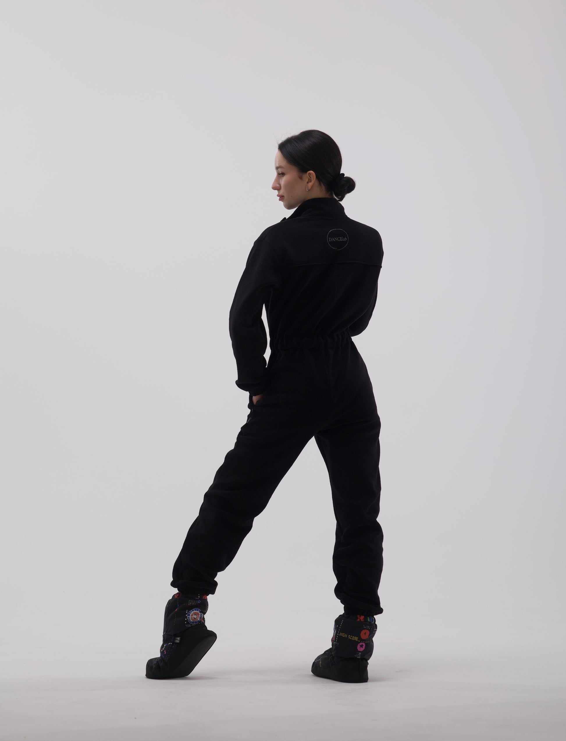 Ballerina posing in fleece overalls by Dancelab