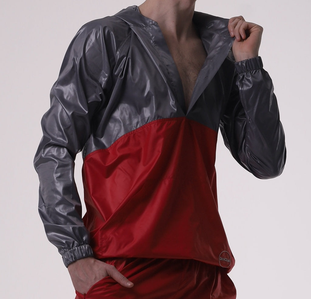 Man wearing a Dancelab jacket with red and gray colors on a plain background