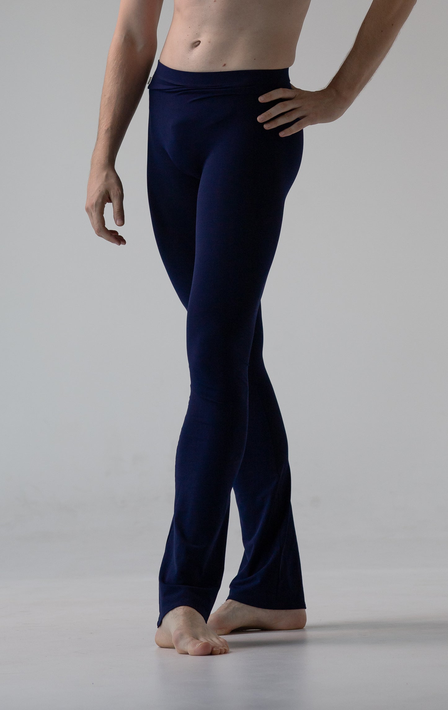 Person wearing navy blue pants on a plain background