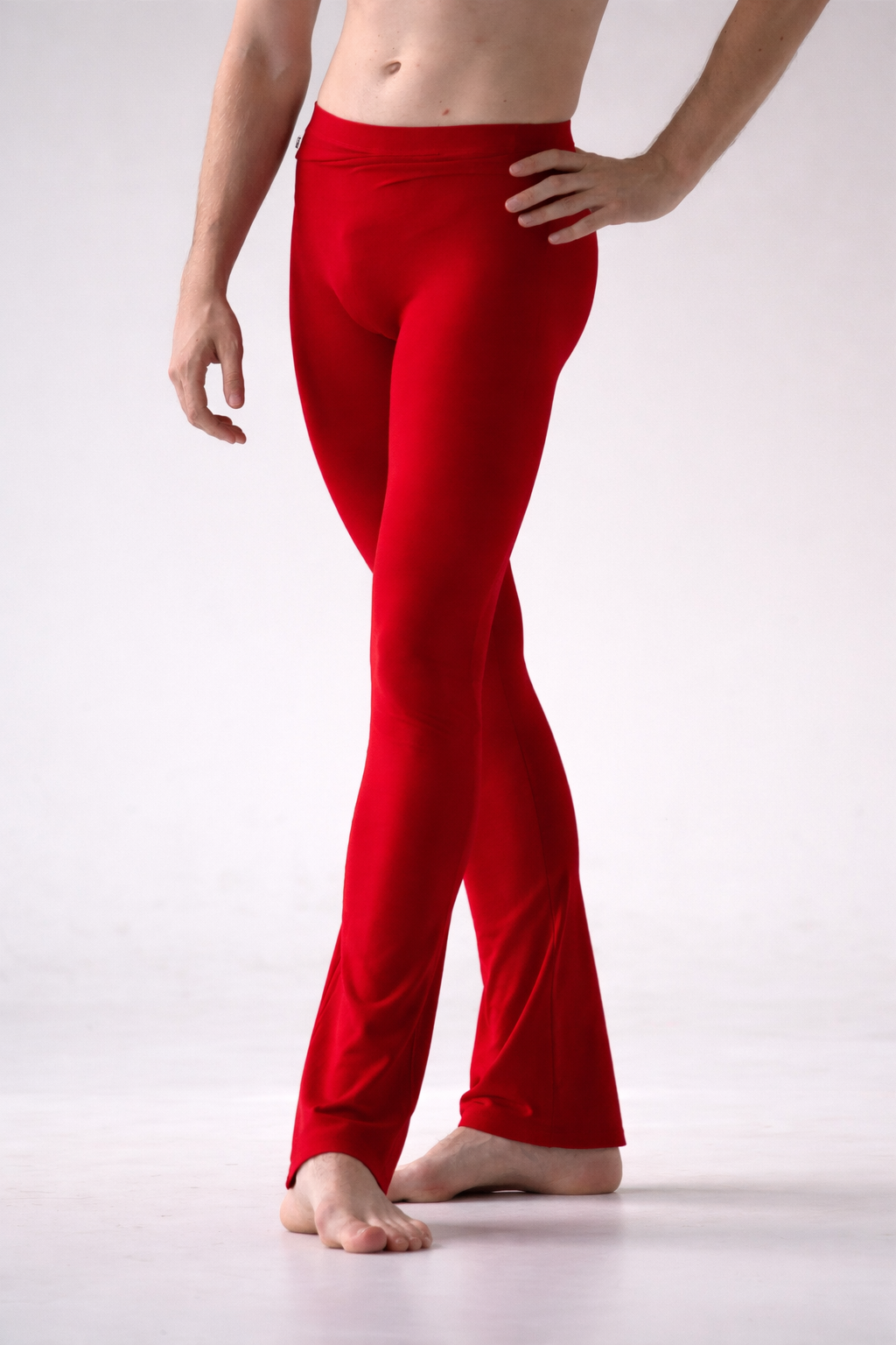 Person wearing red ballet pants on a white background