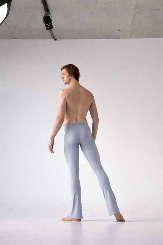 Man wearing light gray tights against a white background