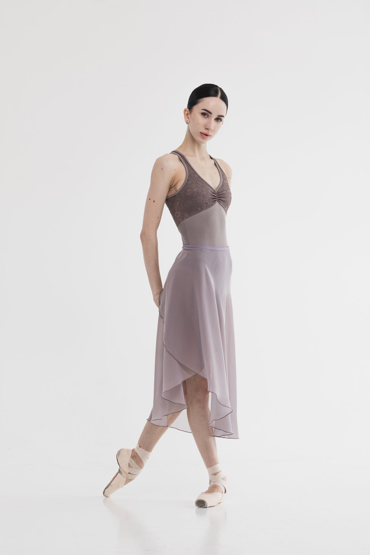 Ballerina in a beautiful dress with a skirt and leotard cacao color on a white background