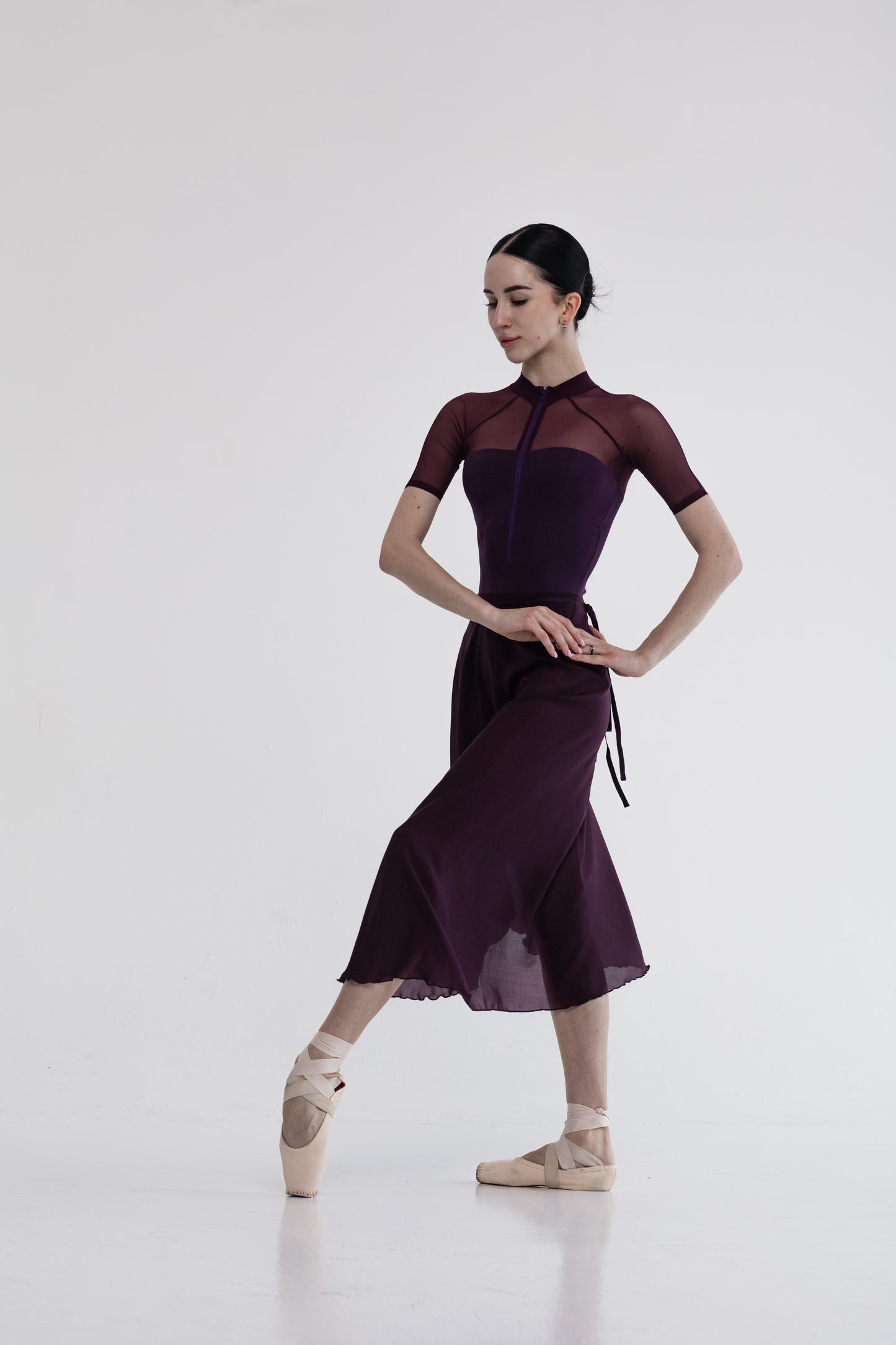 Ballerina in a marsala skirt and stylish leotard Reglan short on a white background