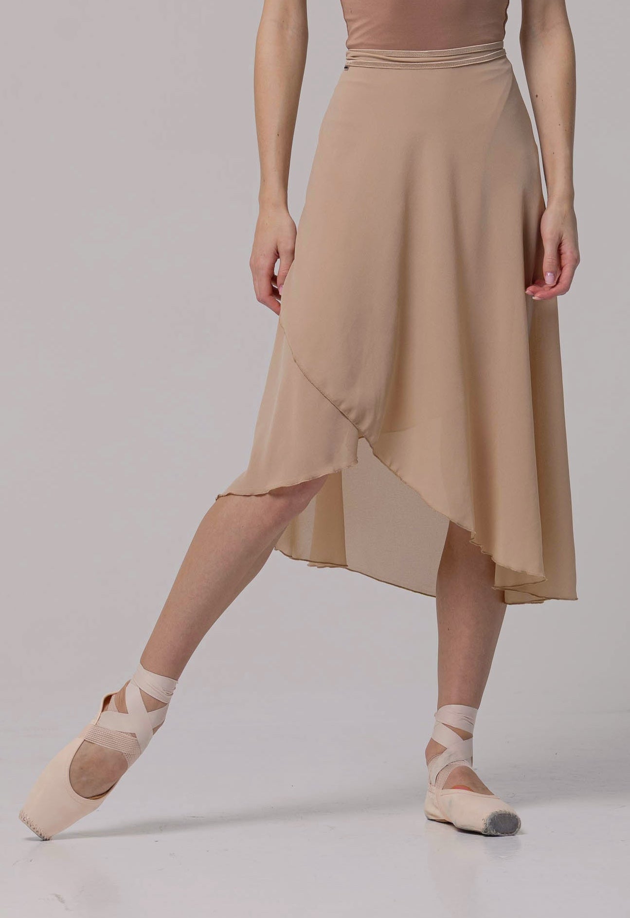 Dancer wearing a ballet skirt on a plain background