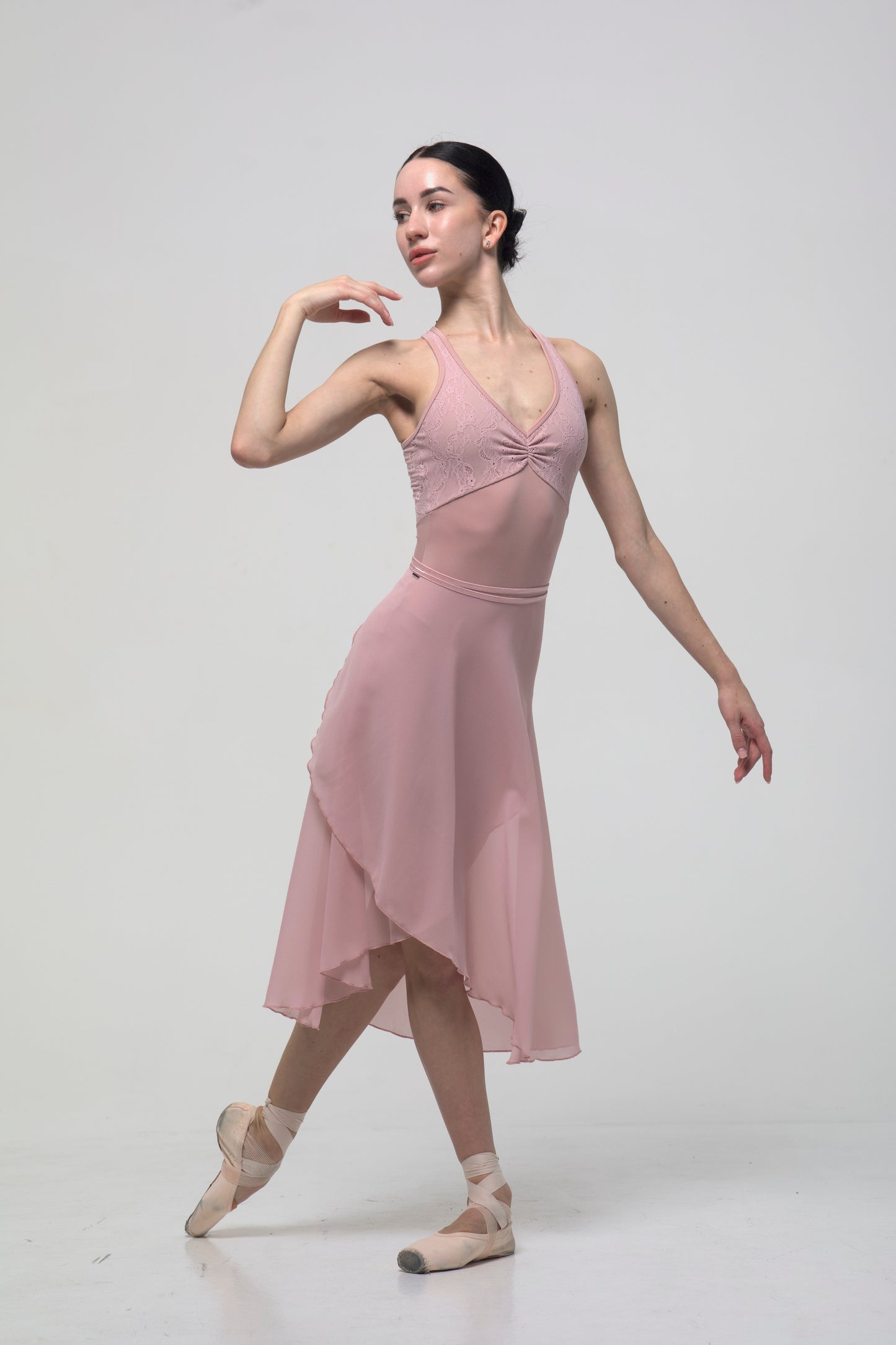 Ballerina in a pink skirt and pink leotard Fleur on a white background
