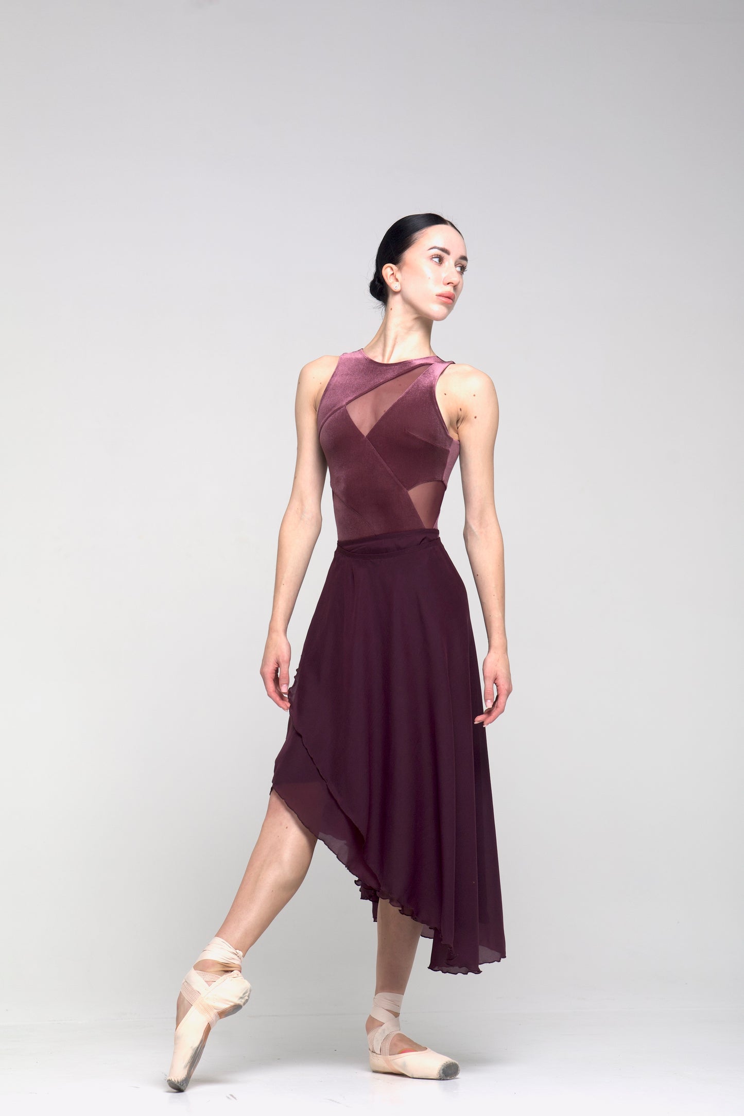Dancer in a marsala skirt on a white background